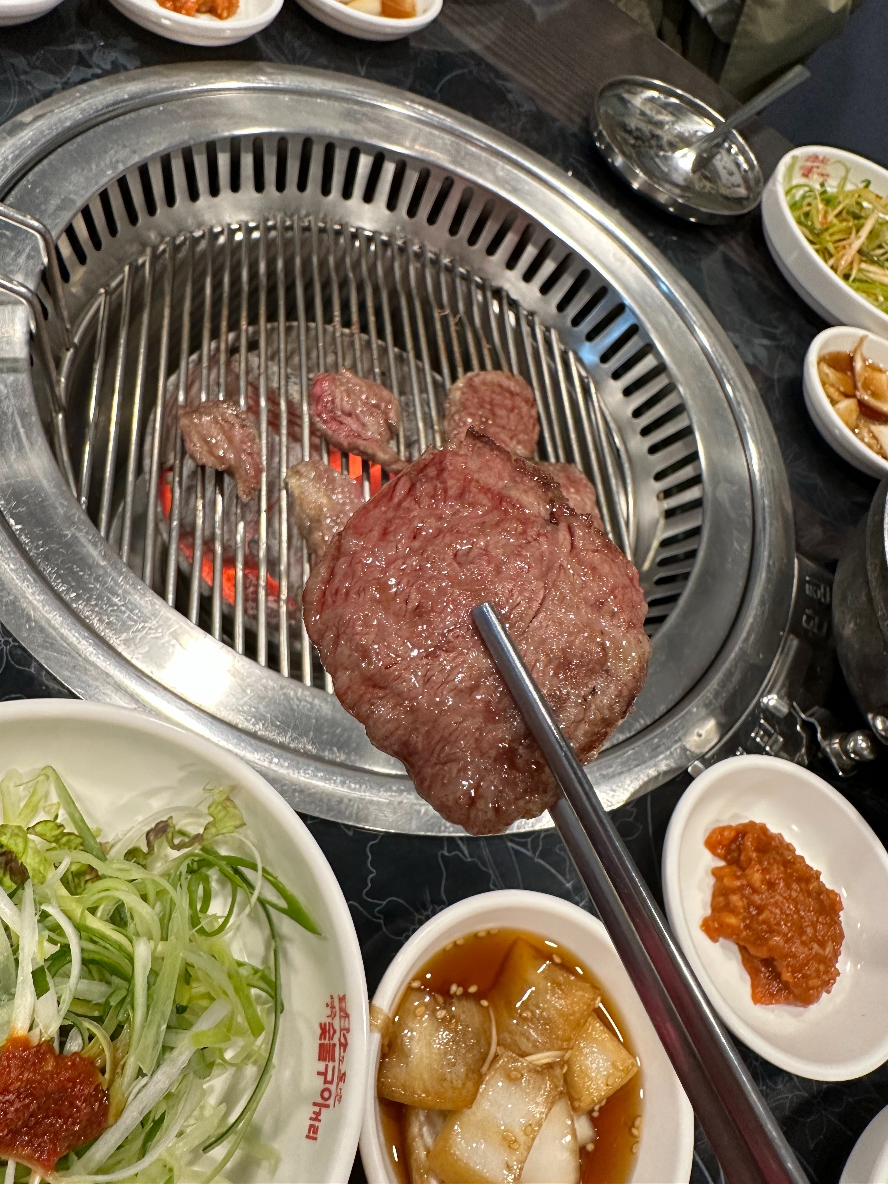 숯불 위에 올라가 익고 있는 소고기 조각들