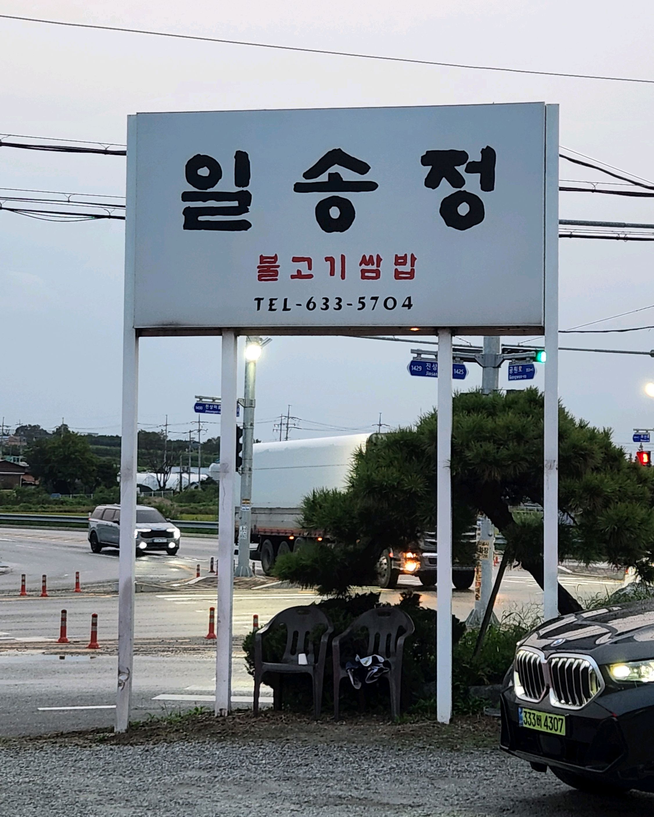 식당 입구에 '일송정 불고기 쌈밥'이라고 쓰인 간판이 보인다.