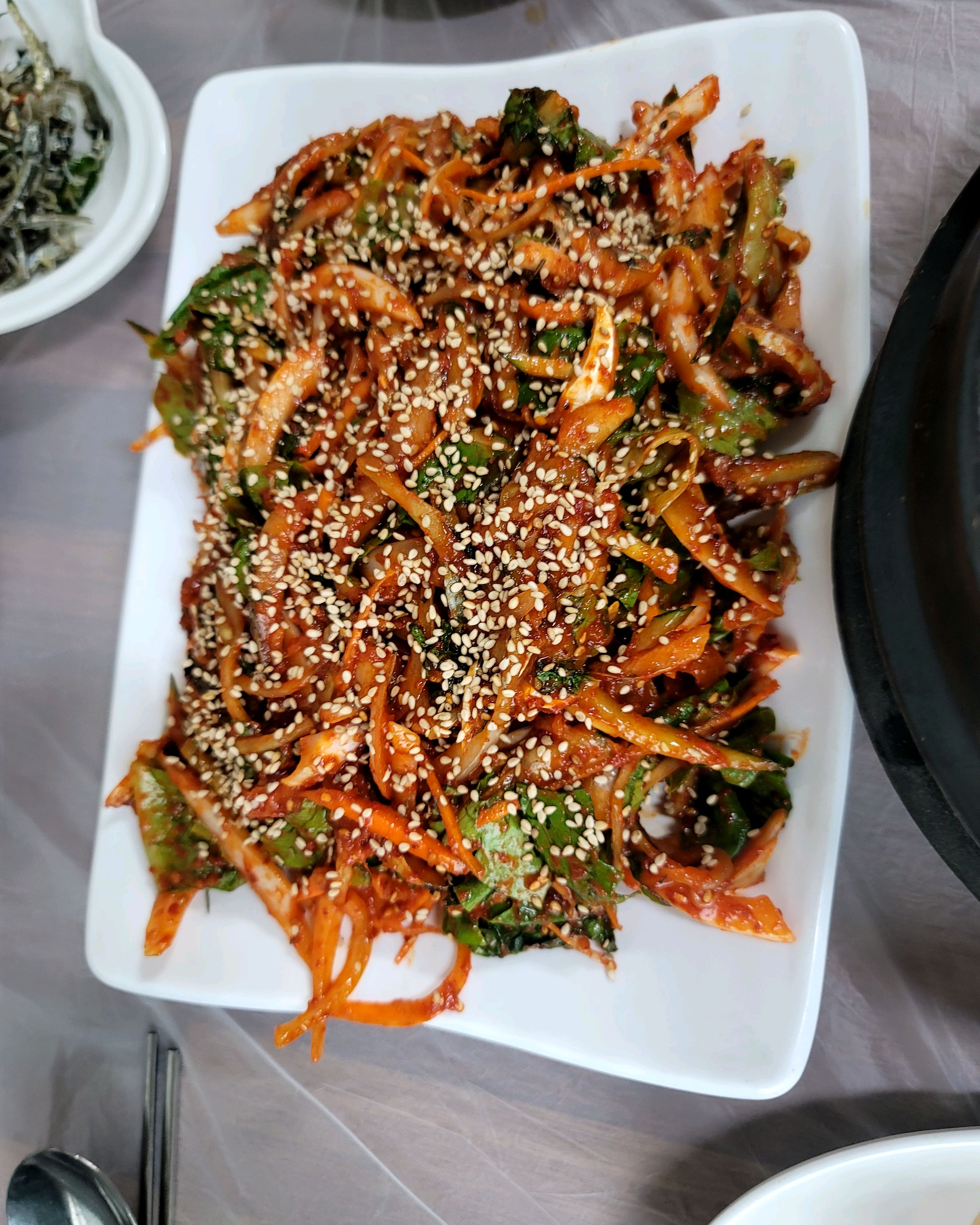 플레이팅된 요리의 윗부분 클로즈업. 참깨가 흩뿌려져 있다.