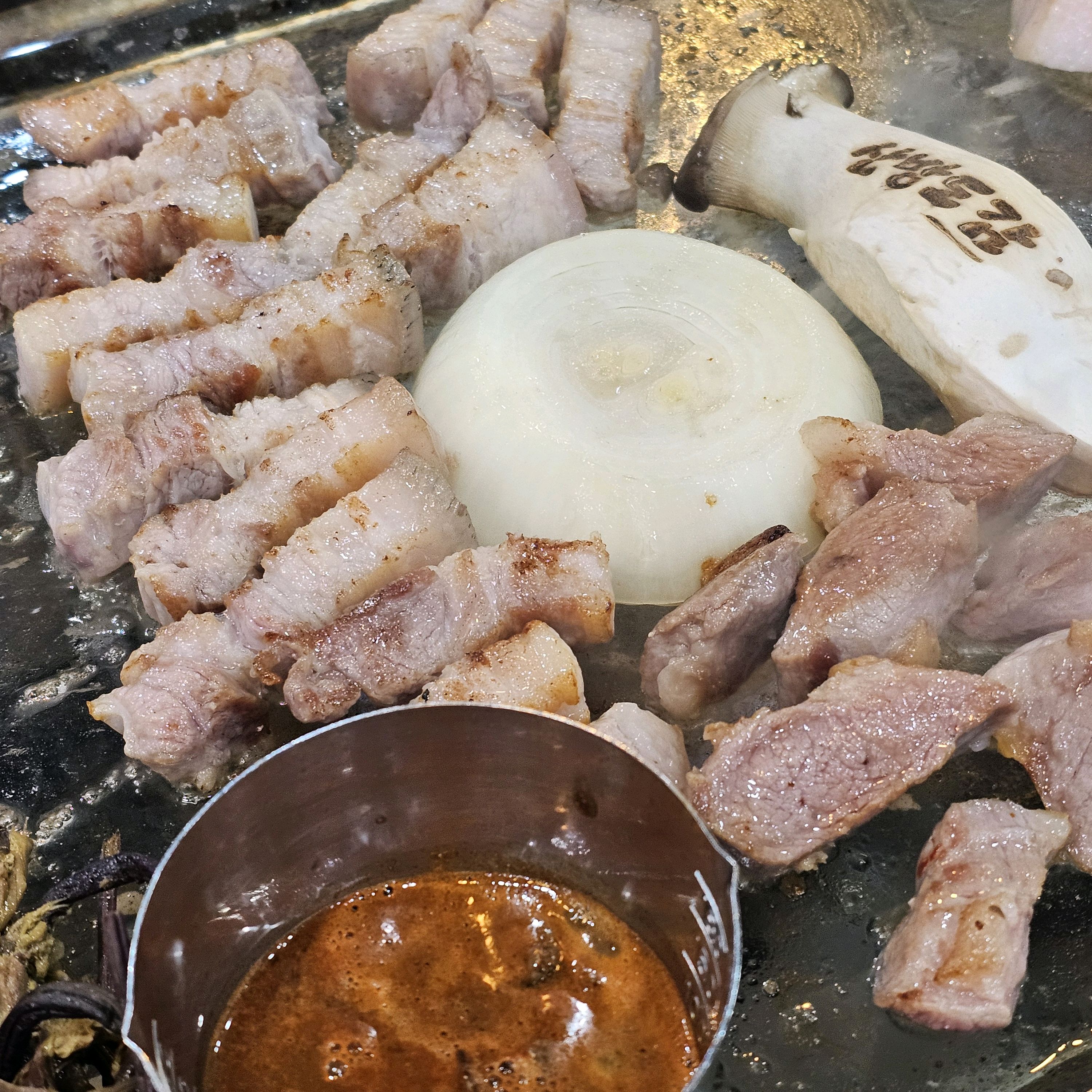 불판 위에 구워지는 흑돼지 오겹살