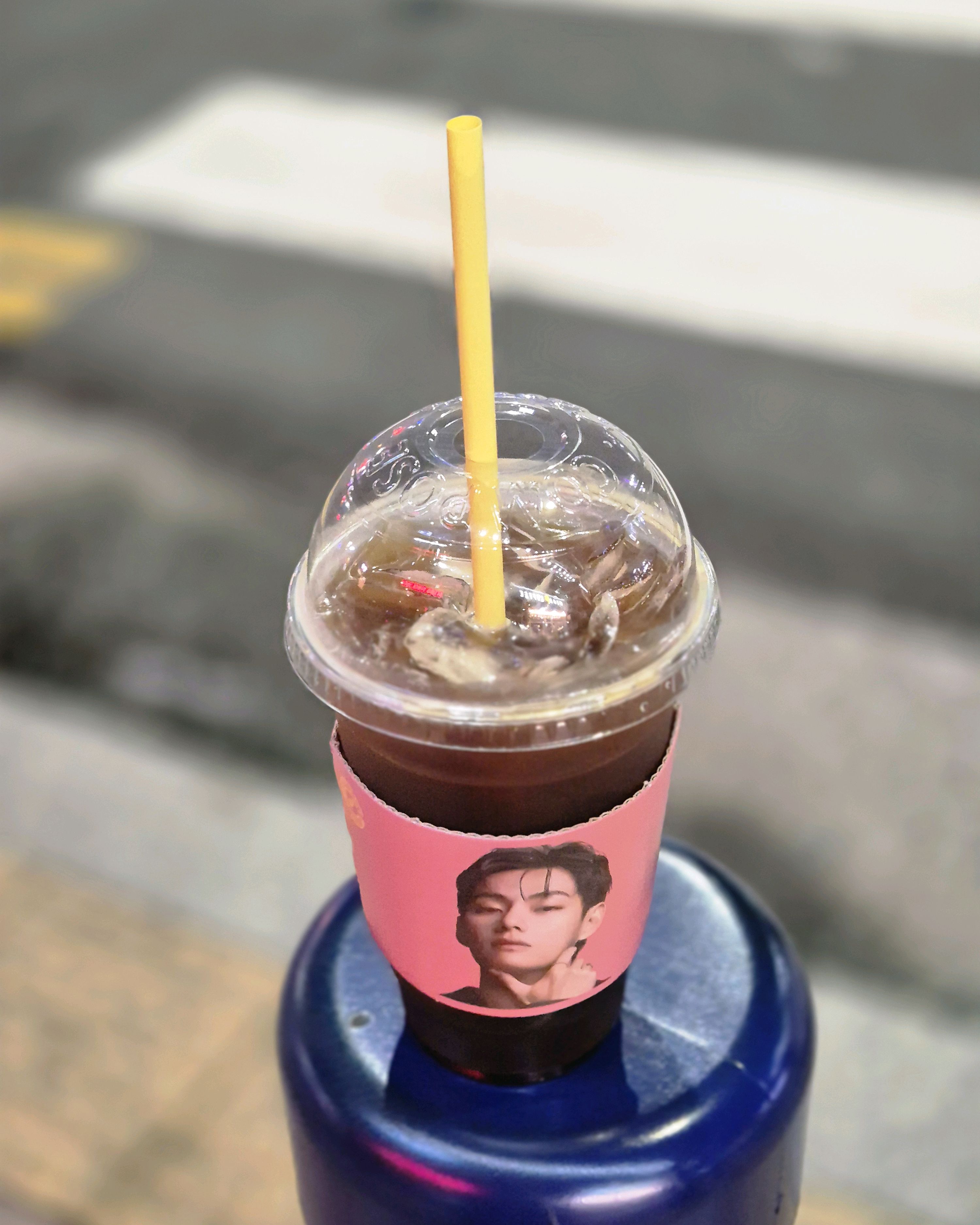 길가에 놓인 컴포즈커피 아이스 아메리카노 컵